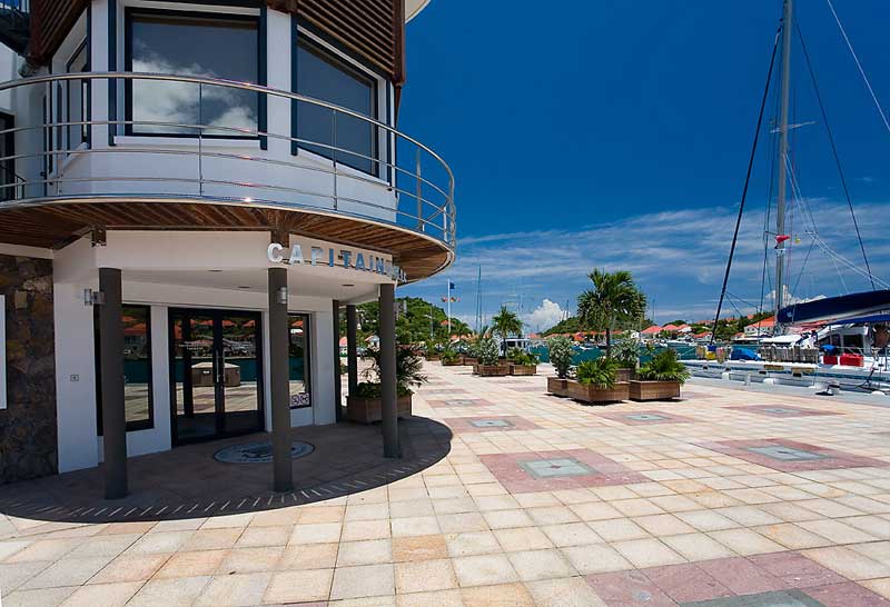 Port de Plaisance, Port of Gustavia. A clean, paved marina entrance with round white building.