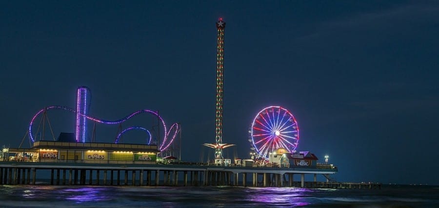 Galveston Island Historic Pleasure Pier lit up at night.