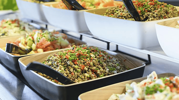 Food neatly displayed in bowls, buffet style.
