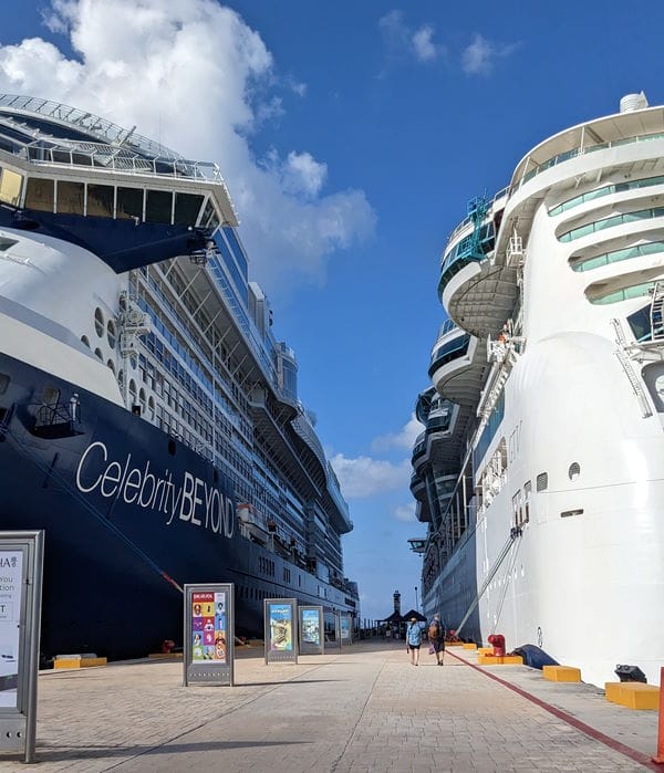 2 cruise ships in Cozumel, Mexico tied to the port docks and people returning to the ship