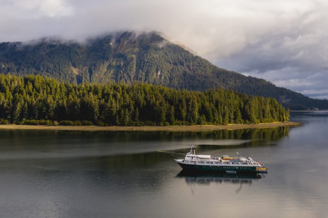 A fishing boat in the water along the Alaskan coast