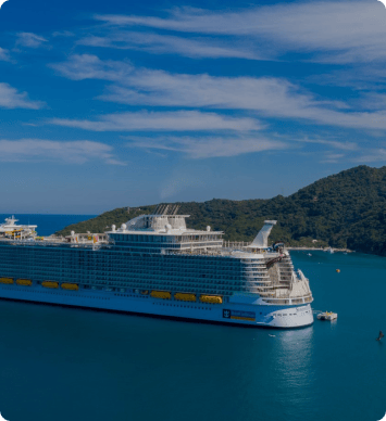 A cruise ship leaving a harbor and heading out to sea