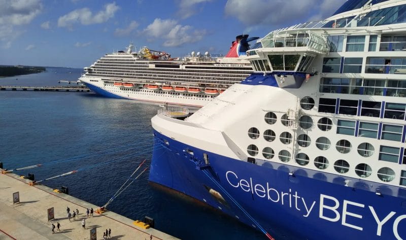 Looking down the promenade in Puerto Vallarta, showing the curve in the coastline, with resorts and city in the background.