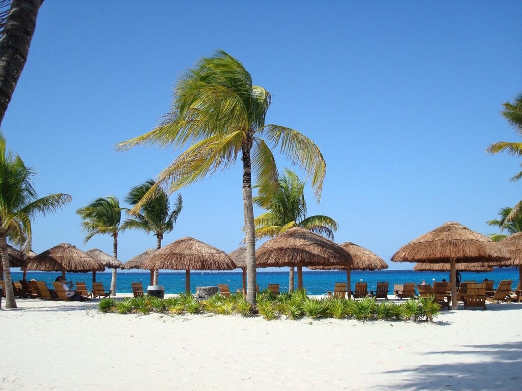 beach in Cozumel with beach umbrellas and blue sky